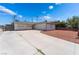 Home exterior featuring an extended driveway and desert landscaping at 704 N Wallace Dr, Las Vegas, NV 89107