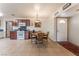 Open floorplan features a kitchen and dining area with natural light and direct access to the front door at 704 N Wallace Dr, Las Vegas, NV 89107