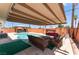 Relaxing backyard oasis with a refreshing pool and shaded seating area at 704 N Wallace Dr, Las Vegas, NV 89107