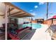 Inviting backyard featuring a private pool, lounge swing, and gazebo with a hot tub at 704 N Wallace Dr, Las Vegas, NV 89107