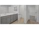 Bright bathroom boasts a double sink vanity with sleek cabinets and a toilet in a separate area at 7086 Parkallen Ave, Las Vegas, NV 89113