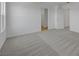 Bonus room featuring neutral carpet, access to other rooms, and lots of light at 7086 Parkallen Ave, Las Vegas, NV 89113