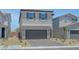 Charming two-story home with a gray exterior, well-manicured landscaping, and a two-car garage at 7086 Parkallen Ave, Las Vegas, NV 89113