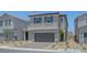 Charming two-story home with a gray exterior, well-manicured landscaping, and a two-car garage at 7086 Parkallen Ave, Las Vegas, NV 89113