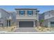 Charming two-story home with a gray exterior, well-manicured landscaping, and a two-car garage at 7086 Parkallen Ave, Las Vegas, NV 89113