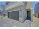 A close up of the home showcasing the garage, entryway, and well-maintained landscaping at 7086 Parkallen Ave, Las Vegas, NV 89113