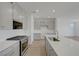 Bright open kitchen with stainless steel appliances, white countertops and gray cabinets at 7086 Parkallen Ave, Las Vegas, NV 89113
