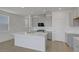 A spacious kitchen with stainless steel appliances, white countertops, and a large island at 7086 Parkallen Ave, Las Vegas, NV 89113
