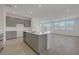 A spacious kitchen with stainless steel appliances, white countertops, and a large island at 7086 Parkallen Ave, Las Vegas, NV 89113
