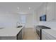 Modern kitchen featuring white cabinets, stainless steel appliances, and a quartz countertop island at 7086 Parkallen Ave, Las Vegas, NV 89113