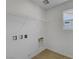 Convenient laundry room area with overhead shelving for efficient storage solutions at 7086 Parkallen Ave, Las Vegas, NV 89113