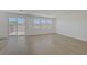 Sunlit living room with sliding glass doors to the backyard and bright, wood-style flooring at 7086 Parkallen Ave, Las Vegas, NV 89113