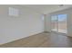 Bright room with sliding glass door and wood-style flooring, allowing for natural light at 7086 Parkallen Ave, Las Vegas, NV 89113