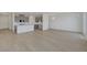 Open-concept kitchen and living space with modern finishes and wood-style flooring at 7086 Parkallen Ave, Las Vegas, NV 89113