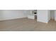 Open-concept living area with wood-style floors, leading to the kitchen and bathroom at 7086 Parkallen Ave, Las Vegas, NV 89113