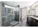 Modern bathroom with a glass-enclosed shower and double vanity, creating a clean and functional space at 7215 Ullom Dr, Las Vegas, NV 89118