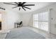 Inviting bedroom with a cozy bed, functional desk, and large windows, offering a serene and productive space at 7215 Ullom Dr, Las Vegas, NV 89118