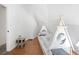 Brightly lit bedroom with hardwood floors features unique teepee bed frame and sloped ceilings at 7215 Ullom Dr, Las Vegas, NV 89118