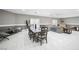 Open-concept dining room with tile floors, a large table, and a comfortable sitting area at 7215 Ullom Dr, Las Vegas, NV 89118