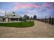 Exterior view of the dome-shaped home with a well-maintained yard and long driveway at 7215 Ullom Dr, Las Vegas, NV 89118