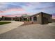 Unique home with a dome feature, covered area, and expansive driveway at dusk at 7215 Ullom Dr, Las Vegas, NV 89118