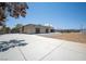 Expansive lot featuring large paved parking and uniquely designed home and clear blue sky at 7215 Ullom Dr, Las Vegas, NV 89118