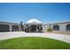 Unique dome home featuring desert landscaping, garage, paved driveway and covered entrance at 7215 Ullom Dr, Las Vegas, NV 89118