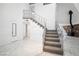 Foyer with staircase and wrought iron railings, wood burning stove, and tile floors at 7215 Ullom Dr, Las Vegas, NV 89118
