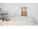 Bright foyer features tile floors, a decorative front door and staircase with wrought iron railings at 7215 Ullom Dr, Las Vegas, NV 89118