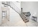 Elegant foyer with a grand staircase and marble tile flooring at 7215 Ullom Dr, Las Vegas, NV 89118