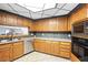 Well-lit kitchen showcasing wood cabinets, stainless appliances and tile backsplash at 7215 Ullom Dr, Las Vegas, NV 89118
