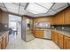 Kitchen with tile floors, stainless steel appliances, and wood cabinets at 7215 Ullom Dr, Las Vegas, NV 89118