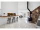 View of a stone fireplace, wet bar and kitchen from the living space at 7215 Ullom Dr, Las Vegas, NV 89118