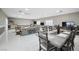 Spacious living room with ample seating and dining area, features tile flooring and natural light at 7215 Ullom Dr, Las Vegas, NV 89118