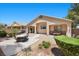 Charming home featuring a covered patio with outdoor seating and a well-maintained yard at 8021 Glacier Falls St, North Las Vegas, NV 89085