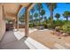 Covered patio overlooking a well-manicured backyard with lush greenery and desert landscaping at 8021 Glacier Falls St, North Las Vegas, NV 89085