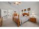 Bedroom with a four-poster bed, matching nightstands, soft lighting, and a ceiling fan at 8021 Glacier Falls St, North Las Vegas, NV 89085