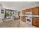 A kitchen with wood cabinets, granite counters, and stainless steel appliances at 8021 Glacier Falls St, North Las Vegas, NV 89085