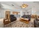Bright living room showcases leather seating, large windows, an open-concept layout at 8021 Glacier Falls St, North Las Vegas, NV 89085