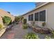 Backyard featuring a stone bench, gravel, and lush green landscaping against a block wall at 816 Stannard Ct, Henderson, NV 89052