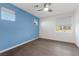 Bedroom with hardwood flooring, blue accent wall, and bright windows at 816 Stannard Ct, Henderson, NV 89052