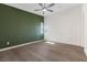 Inviting bedroom with a ceiling fan, large window, and hardwood floors at 816 Stannard Ct, Henderson, NV 89052