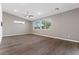 Spacious living room with hardwood floors, natural light, and a modern ceiling fan at 816 Stannard Ct, Henderson, NV 89052
