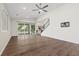 Open-concept living area with hardwood floors, patio access, and staircase at 816 Stannard Ct, Henderson, NV 89052
