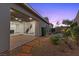Covered patio featuring stone pavers, sliding glass doors and a landscaped backyard at 816 Stannard Ct, Henderson, NV 89052