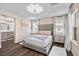 Bedroom with natural light, a large bed with neutral decor, and a view into the ensuite bathroom at 8353 Lower Trailhead Ave, Las Vegas, NV 89113