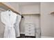Well-organized closet featuring hanging space, drawers, and laundry basket for efficient storage at 8353 Lower Trailhead Ave, Las Vegas, NV 89113