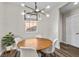 Cozy dining area with a round table, modern chandelier, and large windows providing natural light at 8353 Lower Trailhead Ave, Las Vegas, NV 89113