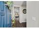 Inviting entryway showcasing a striking blue front door and views into the modern living space with hardwood floors at 8353 Lower Trailhead Ave, Las Vegas, NV 89113