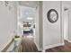 Inviting hallway with warm wood floors, leading to a living area with a comfortable sofa and natural light at 8353 Lower Trailhead Ave, Las Vegas, NV 89113